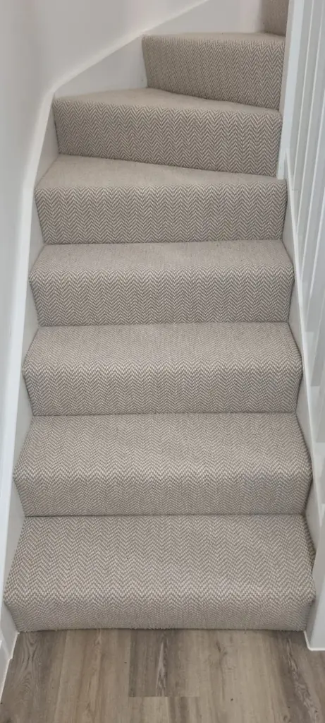 Pale carpet fitted along a straight run of stairs