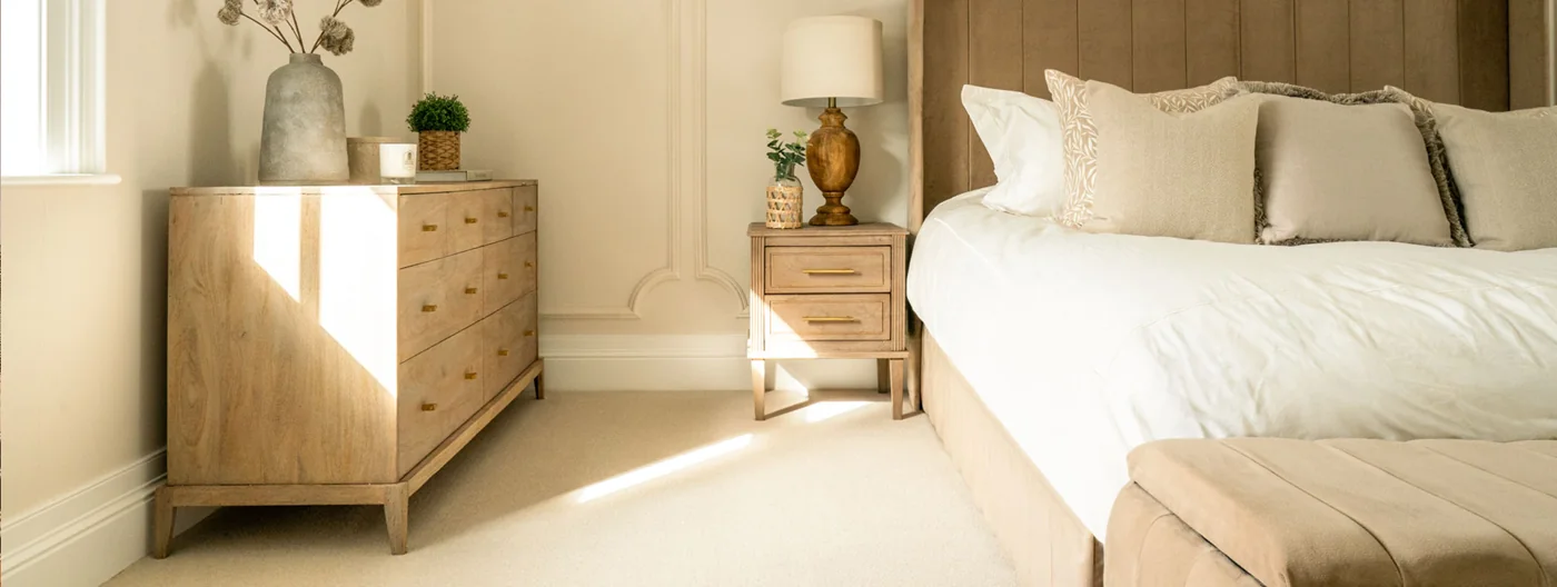 Ulster Grange Wilton Vanilla carpet in a bedroom